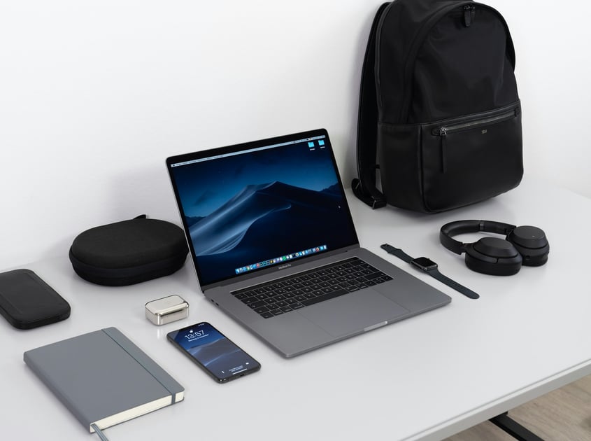 A laptop and a bunch of tech tools on a table for a conference