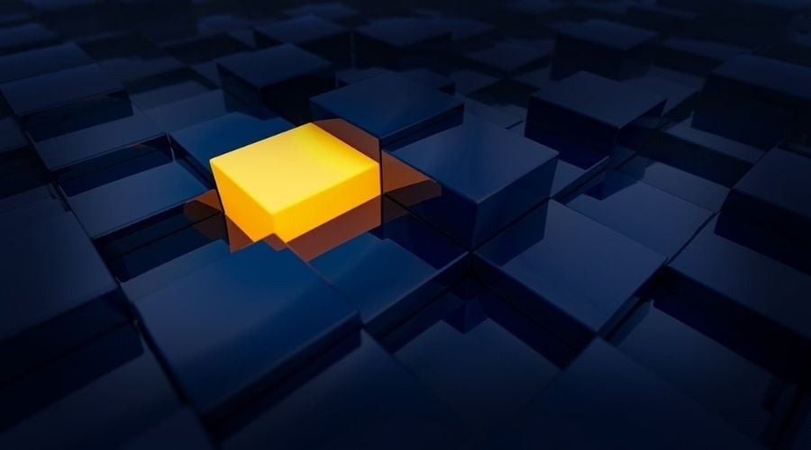 A orange cube among black cubes