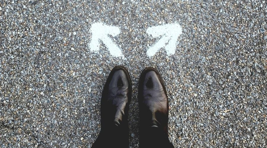 Man standing at a crossroads